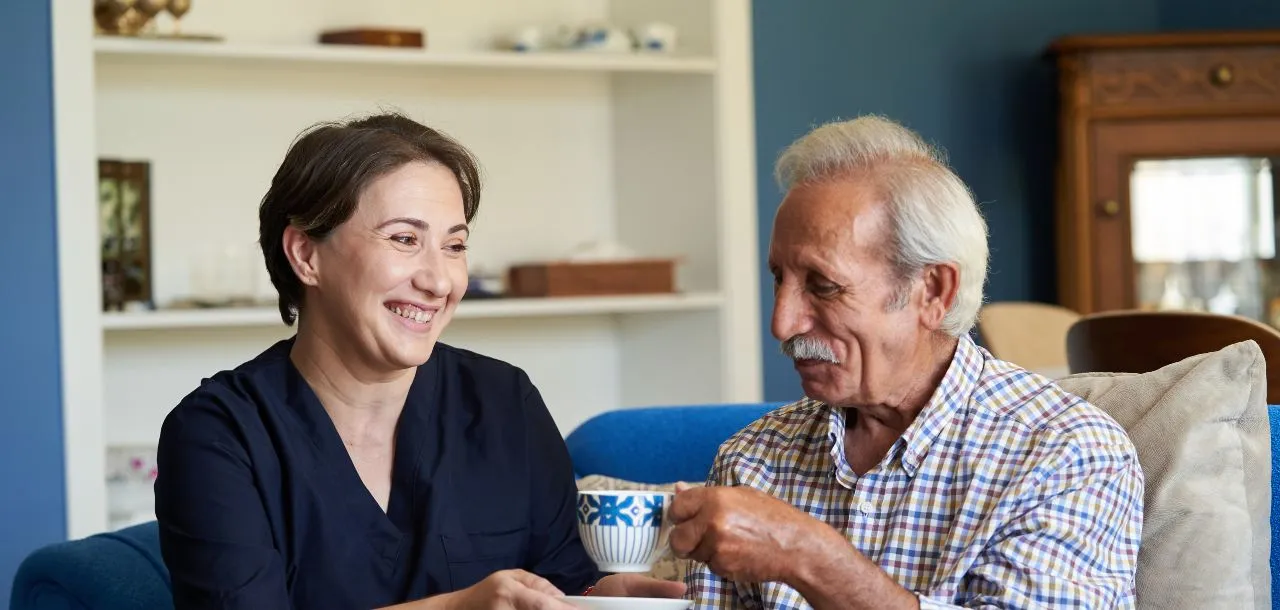 nurse working in an assisted living setting with elderly patient